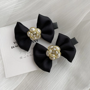 Elegant black satin bow hair clips with pearl camellia flowers and sparkling rhinestones