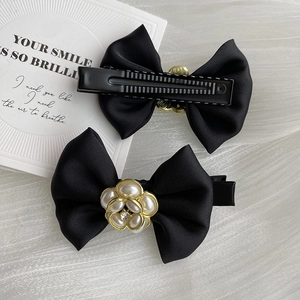 Elegant black satin bow hair clip with camellia flower pearl detail for women