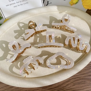 7-piece set of iridescent pearl acetate hair claws with gold-tone metal clips in various shapes