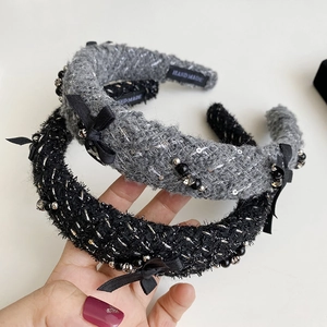 Detail of tweed knit headbands with black bows, beads and silver sequins, handmade finish
