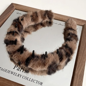 Detailed macro view of the plush leopard print headband showing anti-slip inner teeth