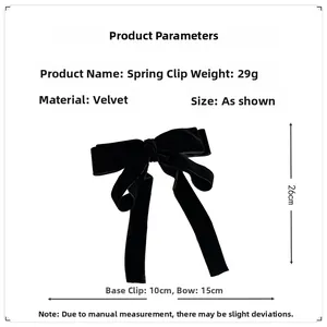 Detail view of black velvet bow hair clip showing spring clip and 26cm tassel length