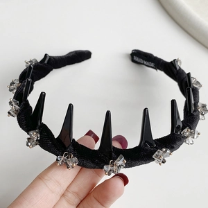 Detail showing black velvet headband with punk spikes and handcrafted crystal embellishments