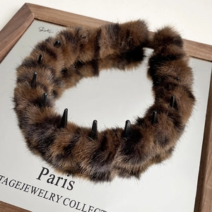 Close-up of brown striped plush headband showing the non-slip inner teeth and soft faux fur