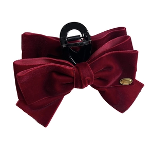 Elegant burgundy velvet bow hair claw clip with golden metal tag and large grip handle