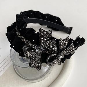 Elegant black velvet headband with rhinestones and a large bow with a heart gem