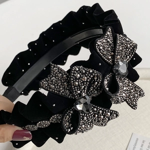Elegant black velvet headband with pleated bows and sparkling heart-shaped gemstones