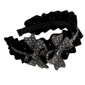 Elegant black velvet headband featuring pleated fabric and rhinestone heart bow accents