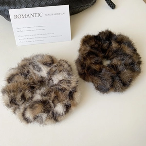 Gros plan de chouchous en fausse fourrure à motif léopard et marron pour cheveux
