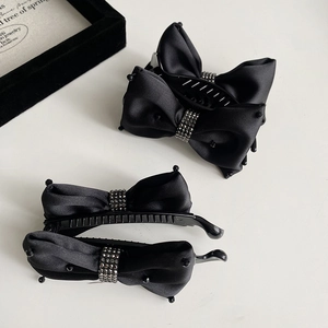 Detailed set of black satin bow hair clips with sparkling rhinestones and a jewelry box