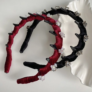 Burgundy and black velvet wavy headbands with sparkling crystal studs on gray background
