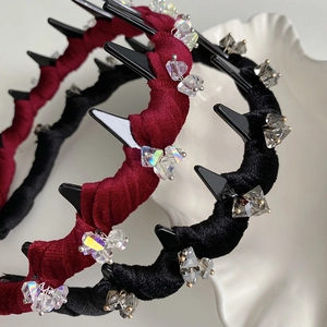 Macro detail of velvet wavy headbands with toothed design and sparkling crystal beads