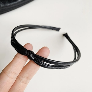 Close-up of the black leather knotted double-strand headband with high-quality texture
