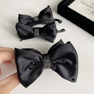 Elegant black satin bow banana clip with crystal rhinestones for a sophisticated hairstyle