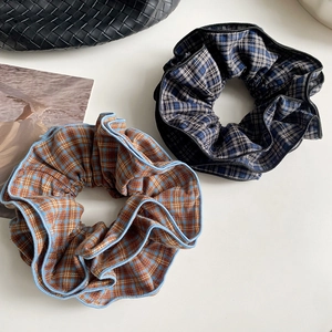 Close-up of four-layer plaid scrunchies with fine stitching and elastic fabric texture