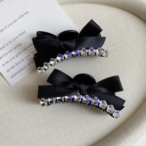 Elegant set of two black ribbon bow hair clips with sparkling rhinestone flower edges