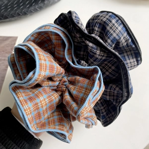 Retro oversized plaid scrunchies in dark brown and navy blue fabric for buns