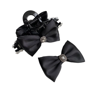 Elegant black satin bow hair clip set with large rhinestone center for women's hairstyling