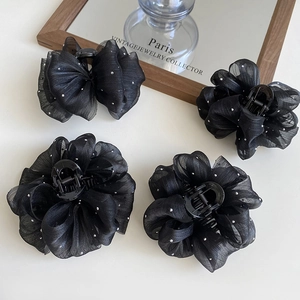 Elegant black tulle dot hair claws set in bubble mesh style for a chic winter look