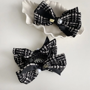 Classic tweed bow hair claw clip with faux pearl detail and black satin accents
