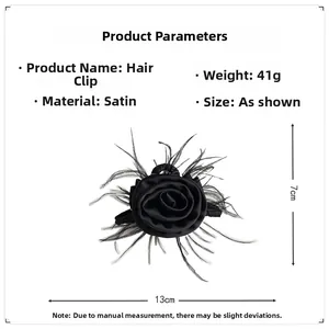 Detail view of large black satin rose hair claw with delicate feathers weighing 41g