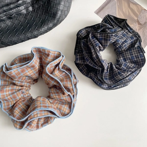 Retro plaid oversized scrunchies in orange and dark blue patterns for autumn hairstyles