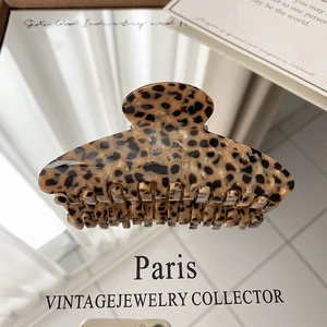 Detailed close-up of leopard pattern hair claw clip with golden Barrette La France logo