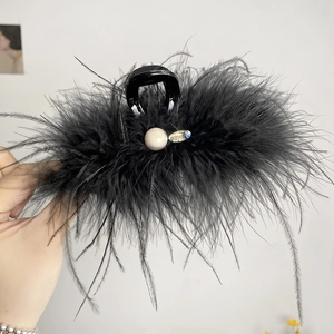 Detail of 13cm black feather hair claw clip with faux pearl and rhinestone accents