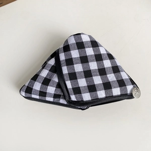 Detail of triangle black and white gingham hair claw clip with bow-knot metal button