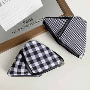 Close-up of black and white gingham triangle hair claw clips with vintage metal buckle