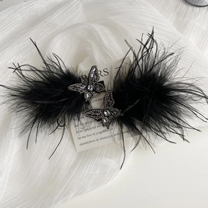 Elegant pair of black feather butterfly hair clips with sparkling dark grey rhinestones