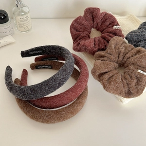 Detail view of handmade knitted headband and scrunchie set in elegant autumn colors