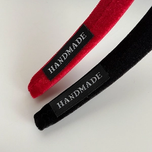 Detail showing high-quality velvet texture and handmade label on vintage headbands