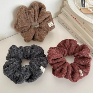 Three-piece set of thick wool scrunchies in brown, dark gray, and maroon for autumn winter