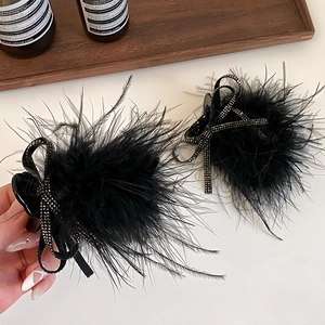 Elegant black feather hair claw with rhinestone bow for high ponytail and bun styling