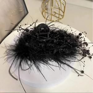 Elegant black feather hair claw clip with pearls for high-volume hairstyles