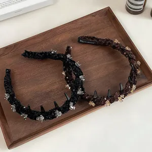 Detailed close-up of handmade sequin headbands with sparkling rhinestones in a tray