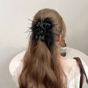 Winter black bow hair claw with ostrich feathers and elegant satin ribbon accessory