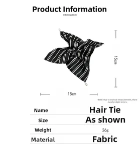 Detailed view of black and white striped satin hair scrunchie with 15cm dimensions