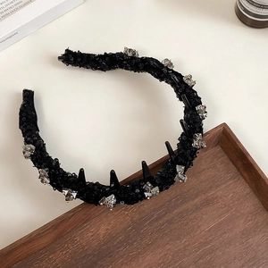 Macro detail of black sequin headband with crystal accents and anti-slip teeth