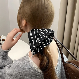 Elegant black and white striped satin hair scrunchie with drop pearl charms on a ponytail