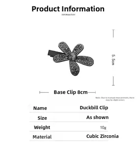 Detailed view of black floral duckbill clip with gray rhinestones showing 8cm dimensions
