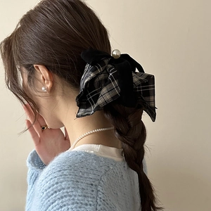 Plaid and velvet bow scrunchie with large white pearl on a braided hairstyle