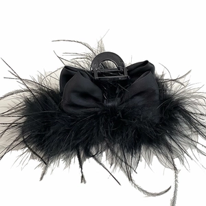 Elegant black hair claw with satin bow and fluffy ostrich feathers in a vintage style