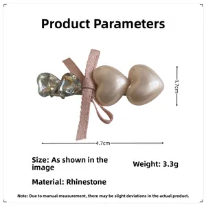 Detailed view of pink bow hair clip with rhinestones and pearls measuring 4.7cm by 1.7cm