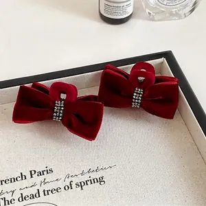 Set of two burgundy velvet bow hair clips with sparkly rhinestone accents for women