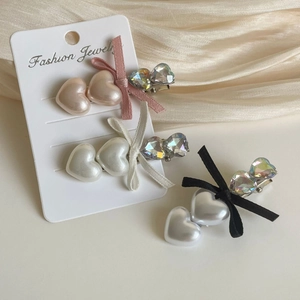 Three elegant heart pearl hair clips with ribbons and sparkling rhinestones on cards