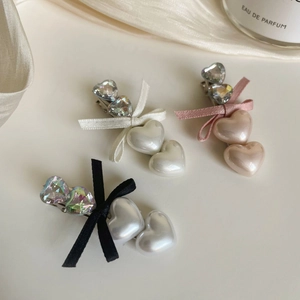 Three-piece vintage bow hair clips with heart rhinestones and pearls in pink, white, and black