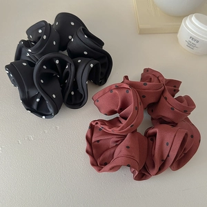 Oversized polka dot scrunchies in black and reddish-brown satin fabric for hair styling