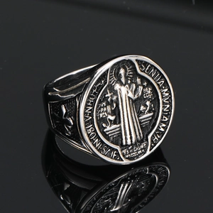 Macro view of St. Benedict vintage steel ring with intricate relief and black reflection